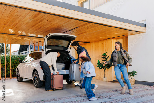 Happy family packing car for road trip vacation