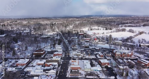 Pittsford, NY, USA - 02-01-2025: Winter afternoon aerial video of the Village of Pittsford four corners with snow on the ground.	