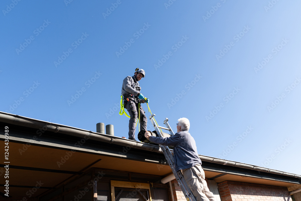 Worker Securing Rooftop Safety Harness Worker Securing Rooftop Safety Harness