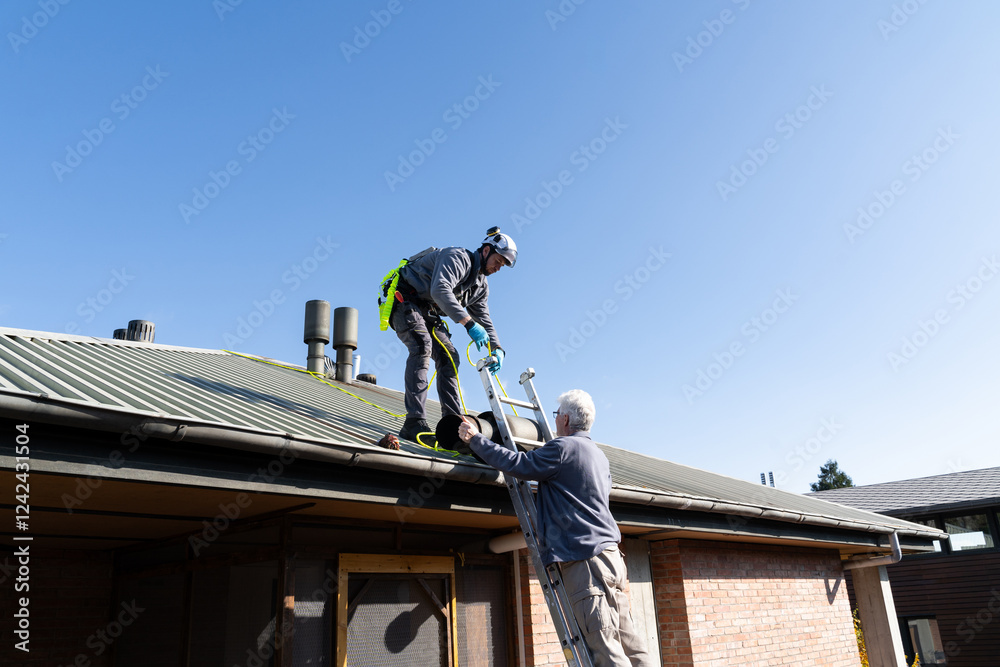 Worker Securing Rooftop Safety Harness Worker Securing Rooftop Safety Harness