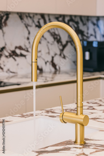 Modern gold kitchen faucet with marble countertop background photo