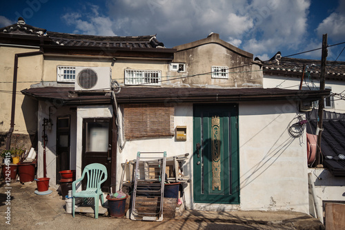 Old house with cheap furniture stashed in front of it photo