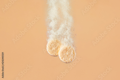 Image of two effervescent tablets dissolving in water