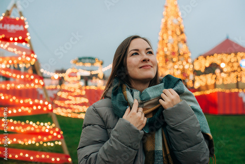 Woman with scarf in festive market during winter holiday season photo