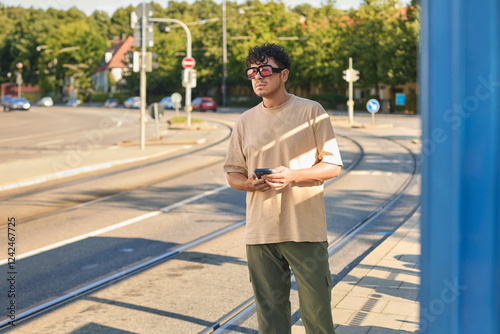 Man Waiting by Tram Tracks photo