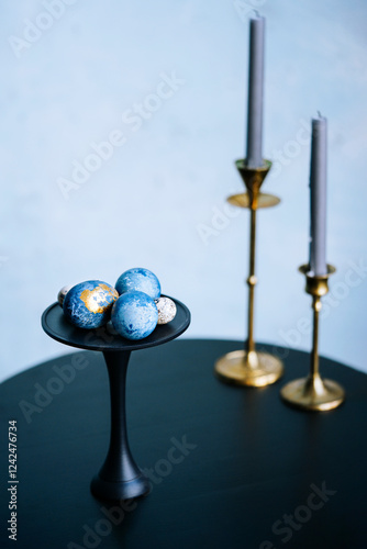 Elegant Display of Decorative Eggs and Candles photo