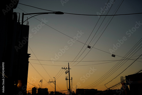 Orange-blue sunset sky over Korean rooftops photo