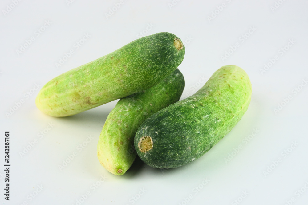 Fresh Green Cucumbers Arranged on a Clean White Background for Culinary Use Fresh Green Cucumbers Arranged on a Clean White Background for Culinary Use