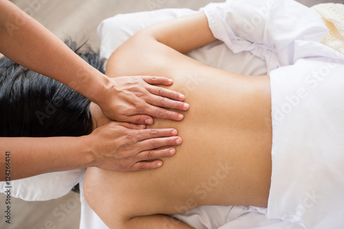 Massage therapist giving a massage on a womans back photo