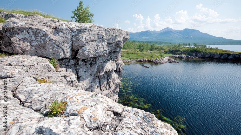 Rocky cliff overlooking calm lake, mountains background, summer