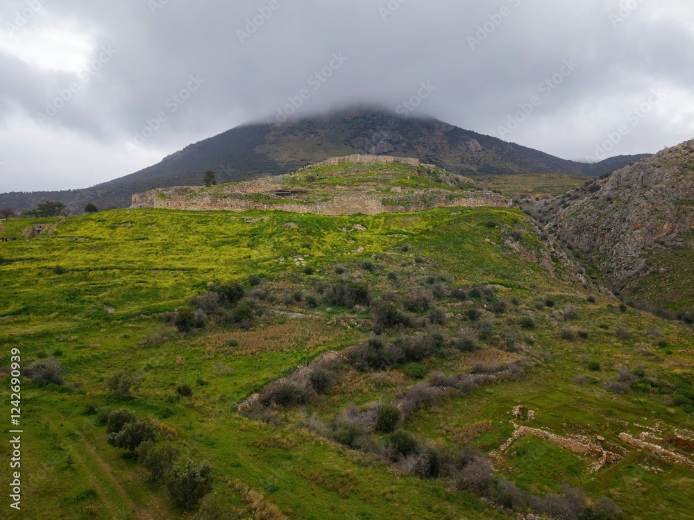 Mycenae, Greece. Excavation site: Greek settlement of the 12th century BC. e. with the ruins of the acropolis, palace and tombs, Aerial View Mycenae, Greece. Excavation site: Greek settlement of the 12th century BC. e. with the ruins of the acropolis, palace and tombs, Aerial View