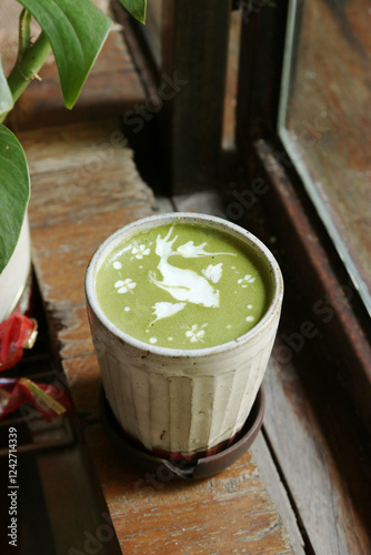 a cup of matcha latte with latte art