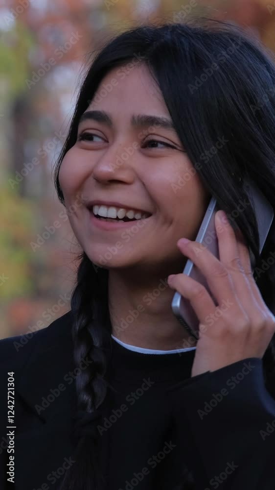Fashionable young female shares a heartfelt conversation on her phone Fashionable young female shares a heartfelt conversation on her phone