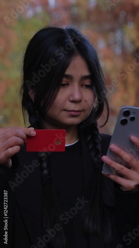 With her mobile banking app, she reviews her finances and makes purchases online, enjoying the digital ease while sitting in nature.