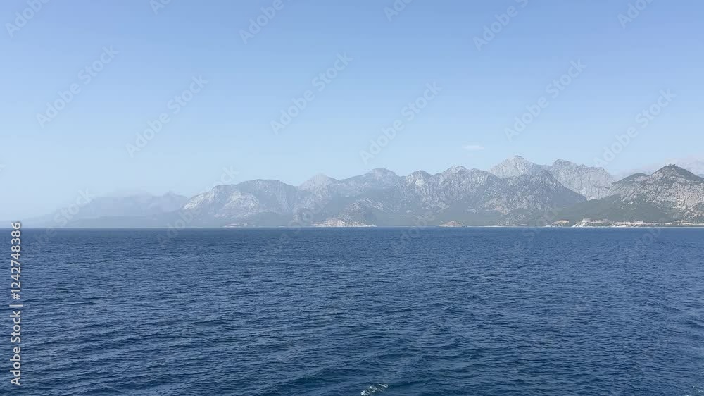 Calm Mediterranean Sea and mountains with the green trees in Antalya Calm Mediterranean Sea and mountains with the green trees in Antalya