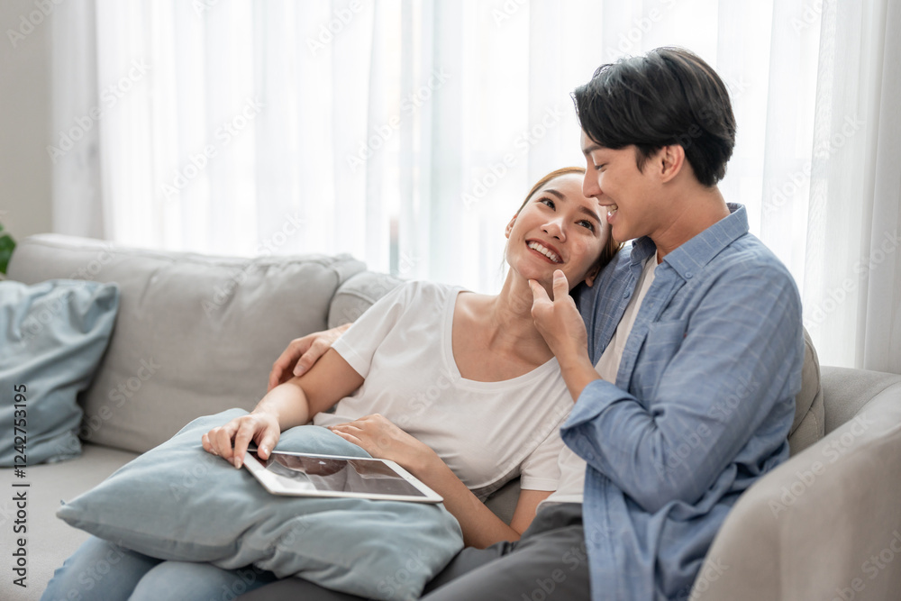 Asian young couple spending free leisure time in living room at home. Asian young couple spending free leisure time in living room at home.