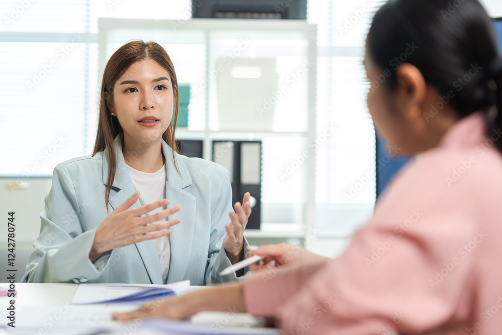 A professional woman engages in a discussion during a meeting, showcasing effective communication and collaboration in a modern office setting. A professional woman engages in a discussion during a meeting, showcasing effective communication and collaboration in a modern office setting.