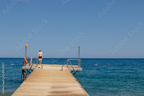 sandy beach and wooden pier, Antalya, Turkey photo