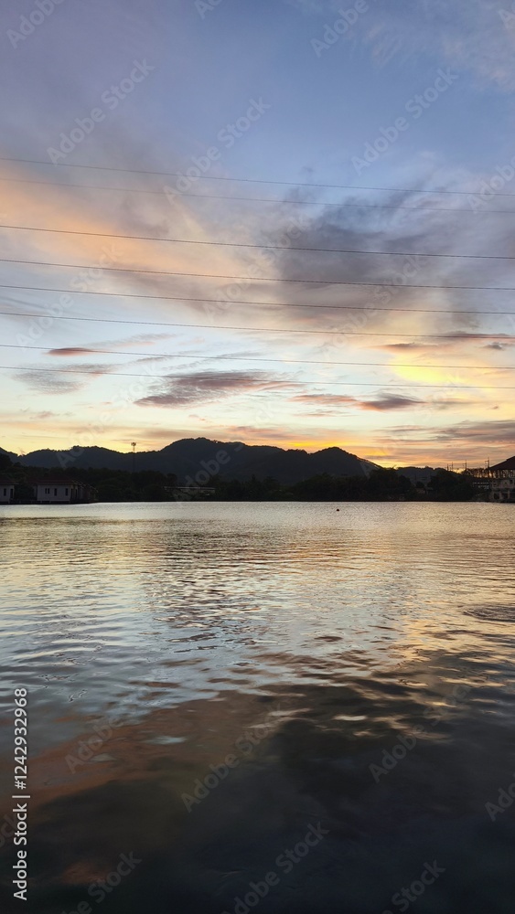 Fototapeta premium Tranquil Sunset Over a Serene Lake in Phuket with Soft Pastel Hues