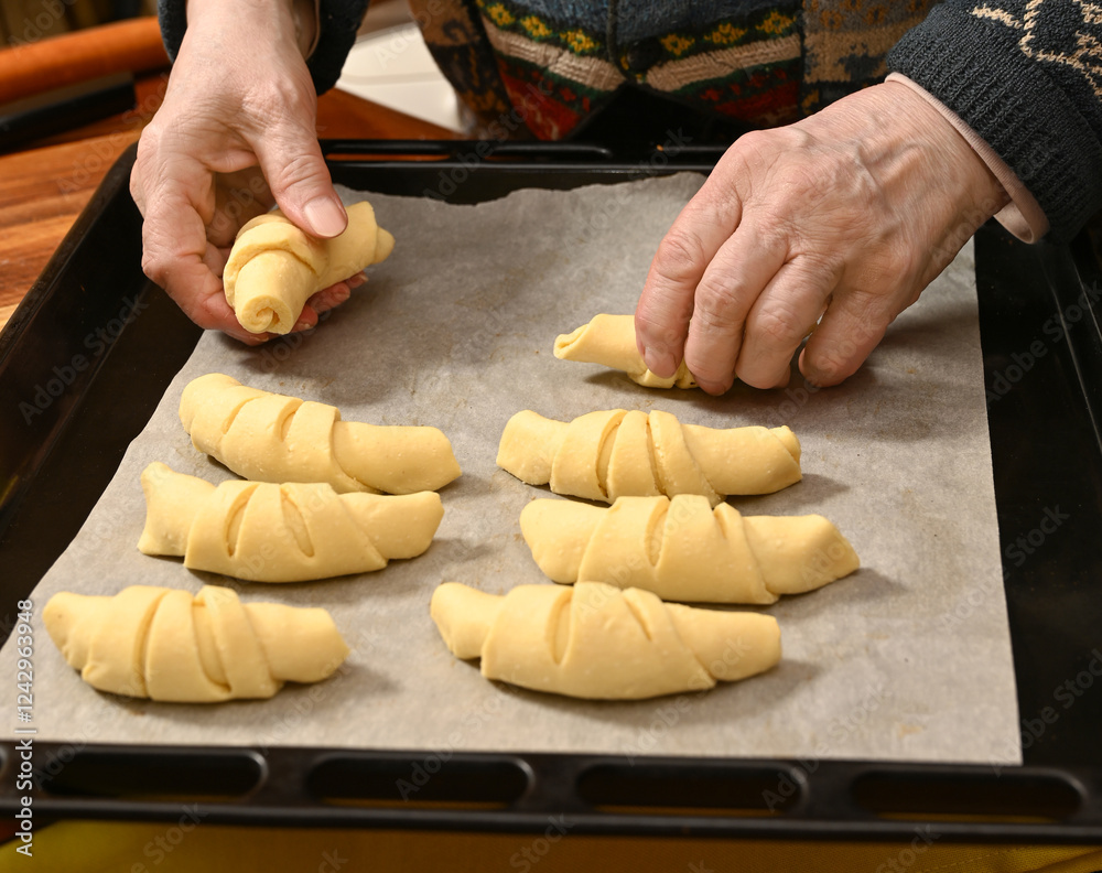 Baking fresh croissants with skilled hands in a cozy kitchen setting during the evening