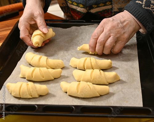 Baking fresh croissants with skilled hands in a cozy kitchen setting during the evening