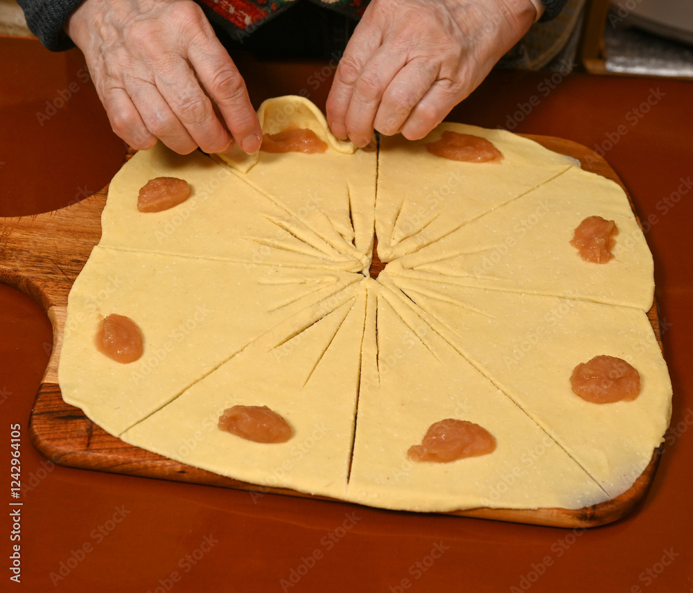 Baking traditional pastry with apple filling in a cozy kitchen setting