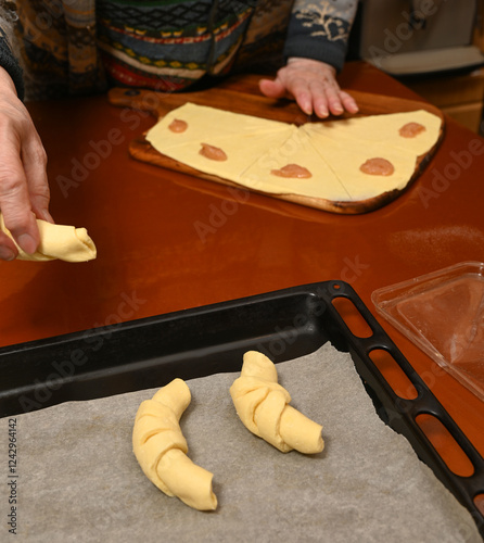 Baking process of homemade croissants with dough preparation and shaping on the kitchen counter