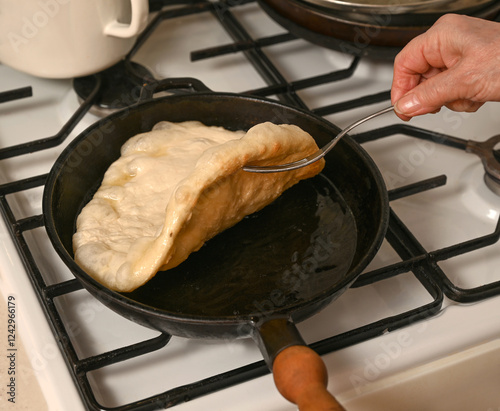 Obraz na płótnie Freshly cooked dough being flipped in a frying pan over the stove during breakfast w salonie