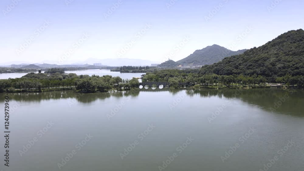 4k aerial video of serene lake landscape with lush greenery and distant mountains in sunny weather 4k aerial video of serene lake landscape with lush greenery and distant mountains in sunny weather