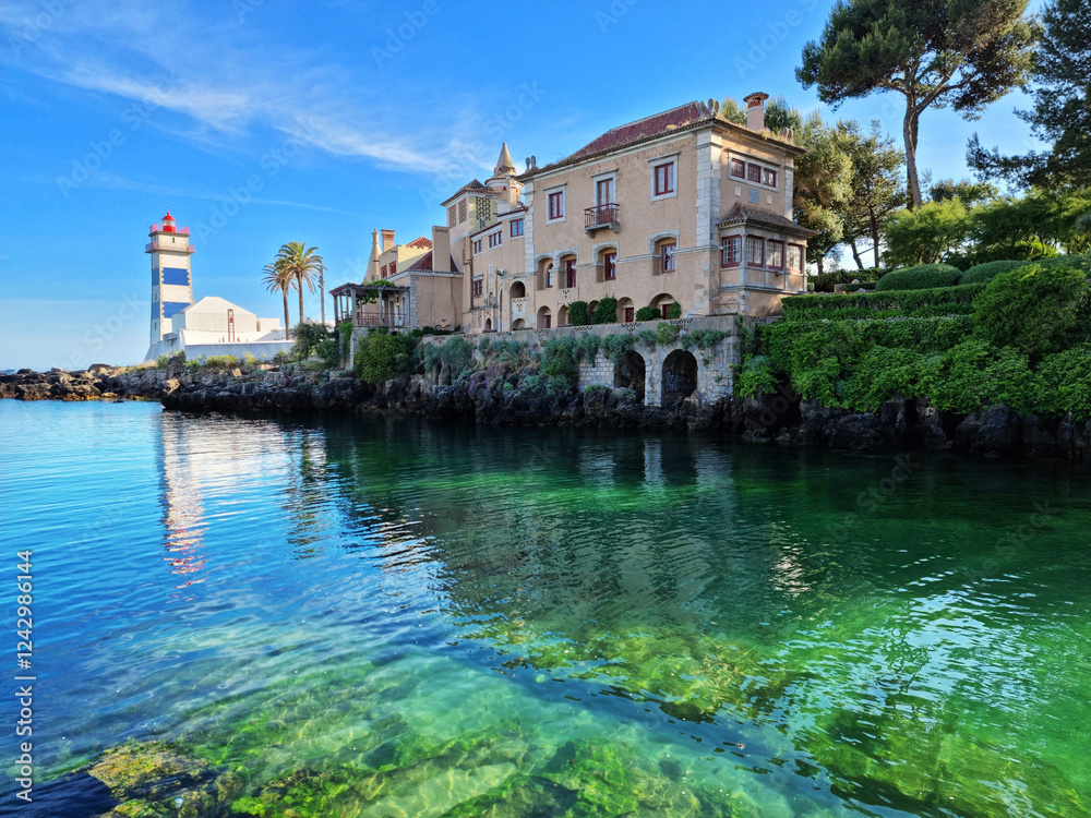 Santa Maria Lighthouse in Cascais, Portugal. Beautiful calm azure water of the bay.