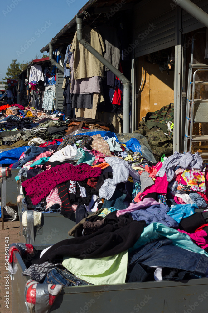 Fototapeta premium Scattered clothes at a flea market