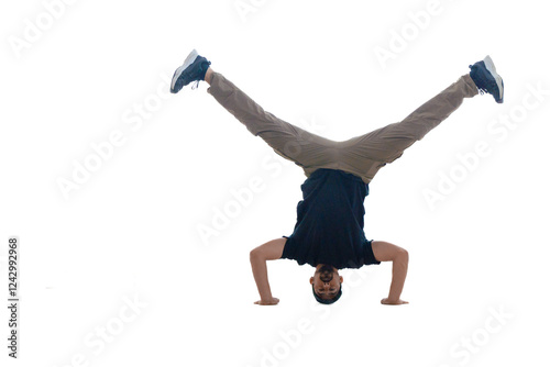 A young man confidently performs an impressive handstand, skillfully showcasing both strength and balance with ease photo