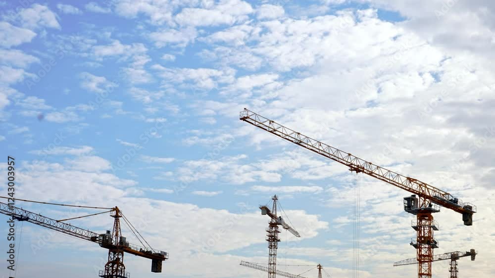 4k aerial video of construction cranes against a bright sky in an urban skyline during summer 4k aerial video of construction cranes against a bright sky in an urban skyline during summer