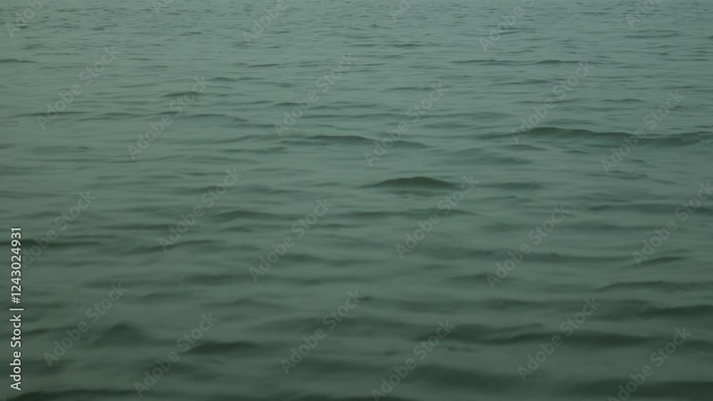Calm water surface with gentle waves in an open body of water, India Calm water surface with gentle waves in an open body of water, India