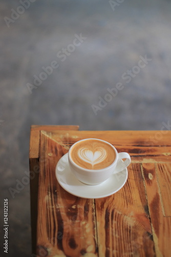 Latte Art Heart in Coffee Cup Sits Beautifully on Wooden Table with Rustic Charm