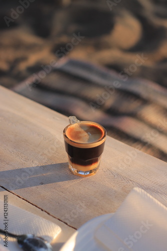 Coffee Sits on Table Outdoors Elegantly at Sunset Tranquilly