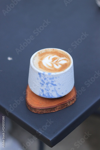 Coffee Cup Sits on Wooden Coaster on Table Elegantly, Brewing Aromatic Pleasure Carefully