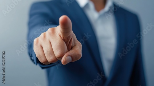 A business professional gestures assertively with a pointed finger, conveying authority and emphasis in a corporate setting. photo