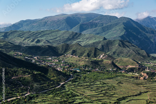 The city of Gunib, high in the mountains, against the backdrop of green mountains, many houses against the backdrop of mountains, Dagestan. photo