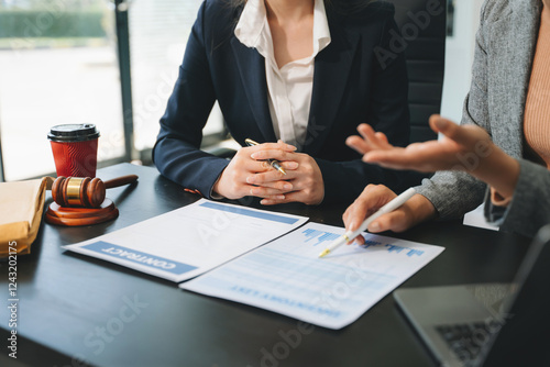 Business and lawyers discussing contract papers with brass scale on desk in office. Law, legal services,