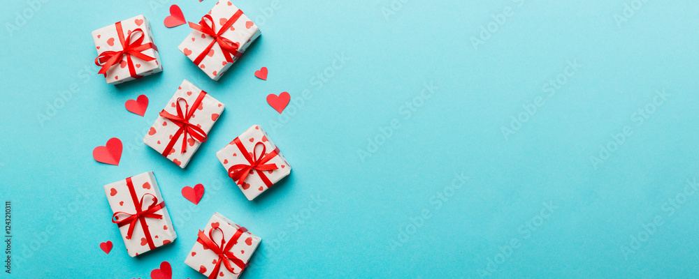 Valentine day composition: red gift box with bow and heart. Christmas present. View from above. Space for text. Holday greeting card Valentine day composition: red gift box with bow and heart. Christmas present. View from above. Space for text. Holday greeting card