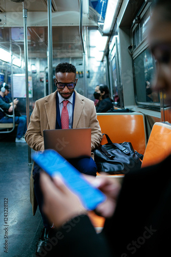 Slika na platnu Businessman working on laptop while commuting by subway train