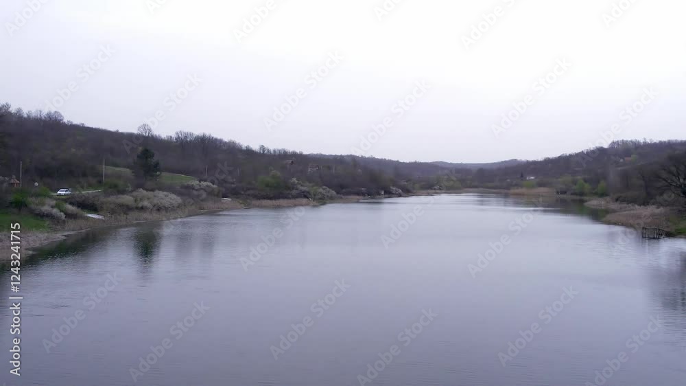 Tranquil river landscape with rocky shores and overcast skies in early spring Tranquil river landscape with rocky shores and overcast skies in early spring