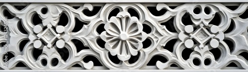 Intricate white architectural relief showcasing floral motifs and geometric patterns on a wall photo