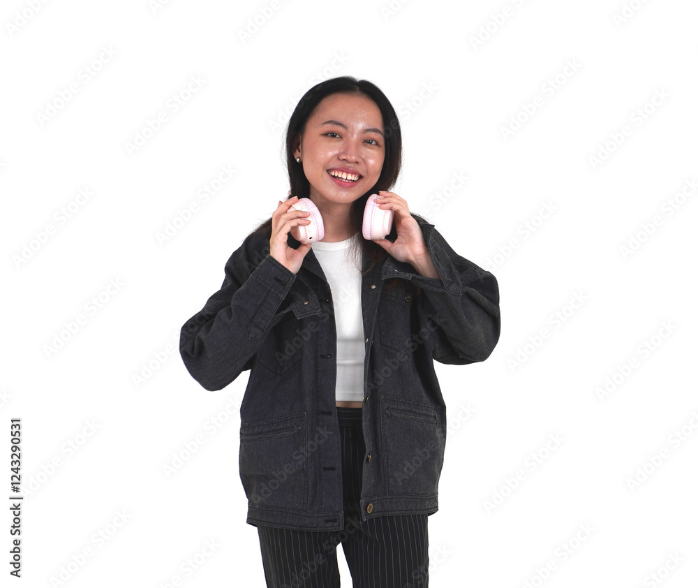 Asian young woman with long hair wearing denim jacket and black pants with hands holding wireless headphone on neck isolated on horizontal white background. Asian young woman with long hair wearing denim jacket and black pants with hands holding wireless headphone on neck isolated on horizontal white background.