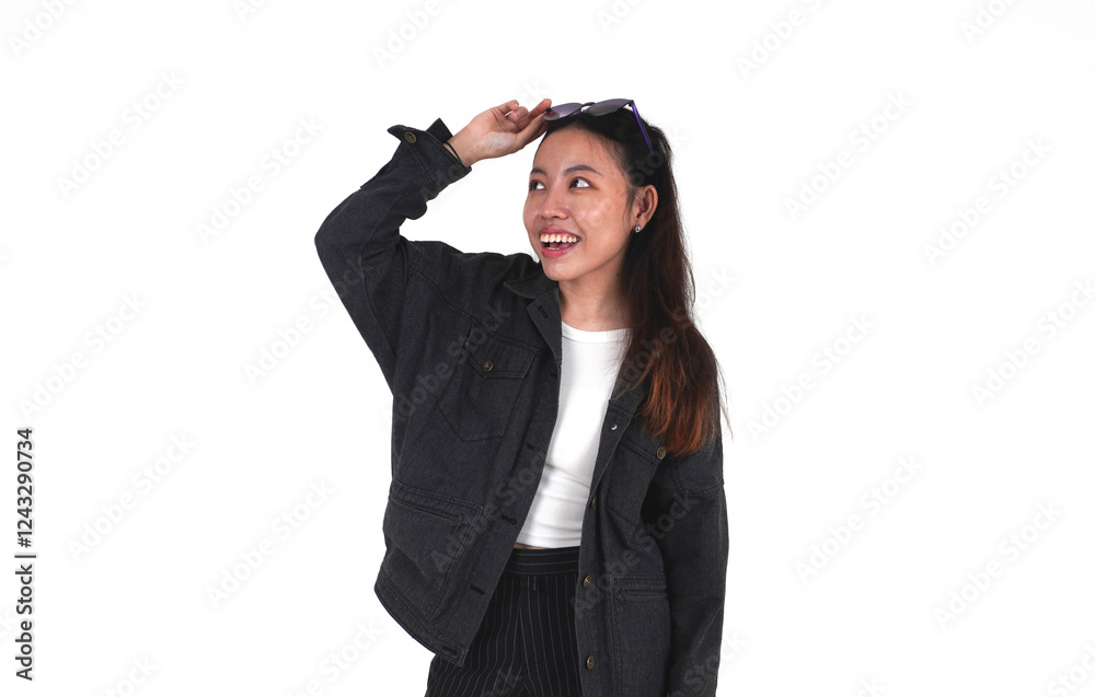Asian young woman looking up with long hair wearing denim jacket and black pants with hand on purple sunglasses hanging on head isolated on horizontal white background. Asian young woman looking up with long hair wearing denim jacket and black pants with hand on purple sunglasses hanging on head isolated on horizontal white background.