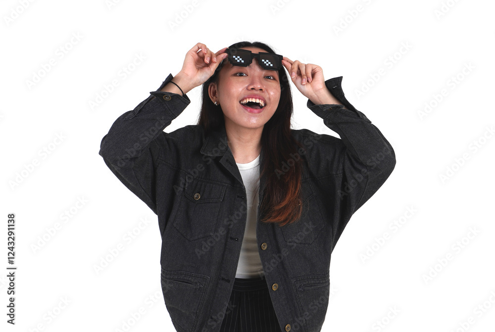 Asian young woman wearing black denim jacket and black pants taking a peek from pixel bit styled sunglasses isolated on horizontal white background. Asian young woman wearing black denim jacket and black pants taking a peek from pixel bit styled sunglasses isolated on horizontal white background.