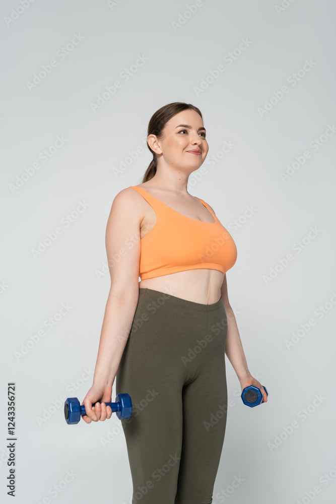 Empowered woman shows strength and confidence while exercising indoors Empowered woman shows strength and confidence while exercising indoors
