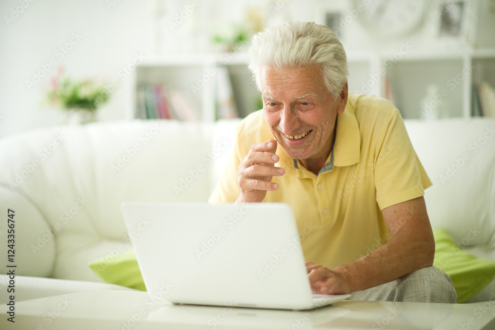 Portrait of senior man with laptop at home Portrait of senior man with laptop at home