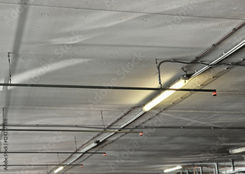 signaling device for the occupancy of parking spaces in the parking garage at the airport or office shopping mall.  the occupancy sensor lights up a red light on the ceiling photo